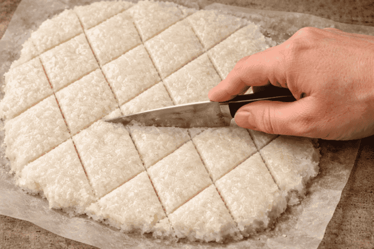 cutting Sri Lankan aluwa into diamond-shaped pieces on a tray