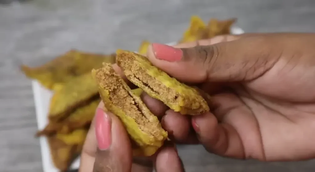 inside texture of Sri Lankan mung kevum showing soft filling and crispy outer layer