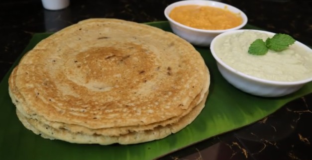 crispy dosa served with coconut chutney and sambar on banana leaf