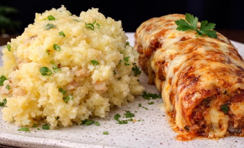 cheesy stuffed rolls served with mashed potatoes on a plate