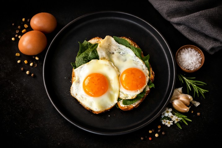 fried eggs on toast with greens protein rich breakfast