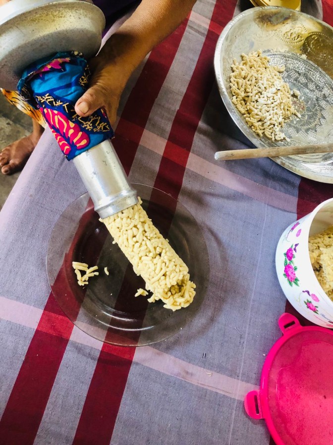 Freshly steamed mani pittu coming out of a traditional pittu steamer