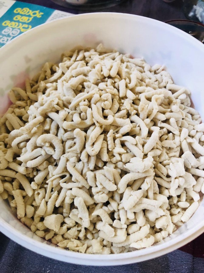 Mani pittu dough pieces after pressing and breaking before steaming