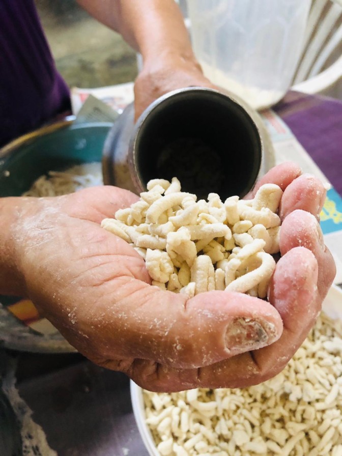 Close-up of mani pittu pieces showing texture before steaming